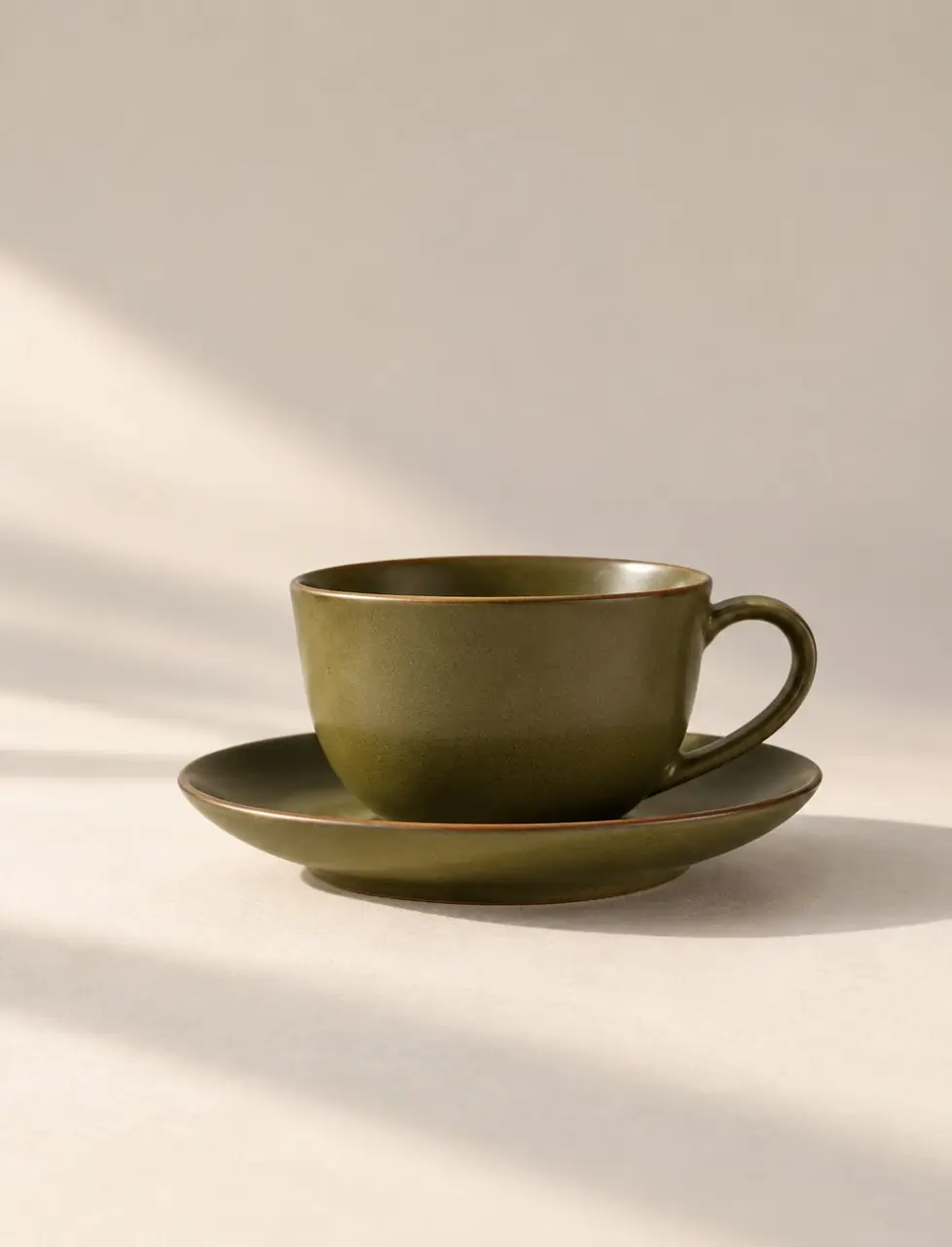 Rounded matcha green cup on a matching saucer